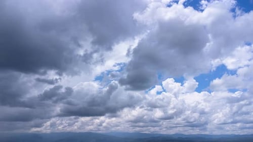 Aerial view of the blue sky with white clouds in summer day.