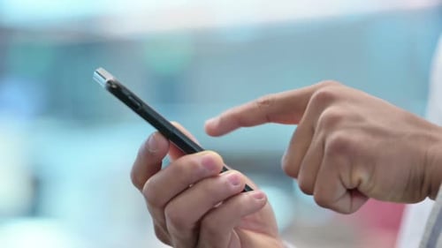 Close Up of African Man Using Smartphone