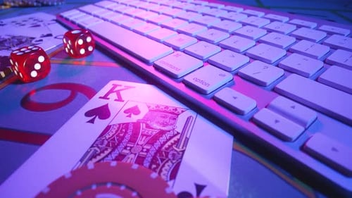 Gaming Table with Computer Keyboard Cards Dice and Casino Chips