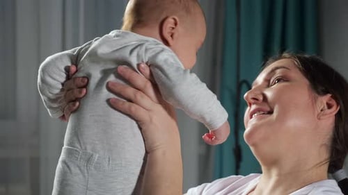 Happy Woman Holding a Smiling Baby