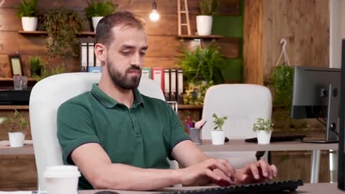 Office Worker in Casual Clothes Works on the Computer