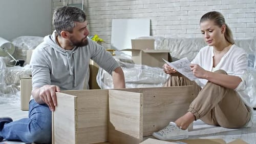 Man and Woman Assembling Shelf