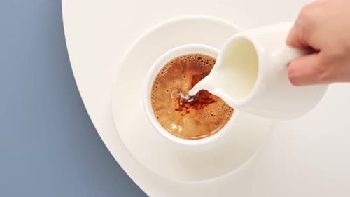 Adding Fresh Milk to a Hot Cup of Coffee