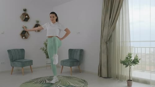 Woman Doing Leg Exercises at Home on a Mat