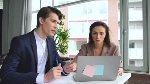 Young hipster business group working together and brainstorming for ideas in loft office.