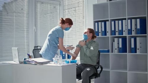 Adult Receives Vaccine from Medical Professional