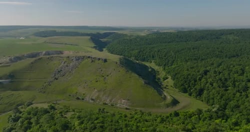 aerial view on canyon with small river and forest