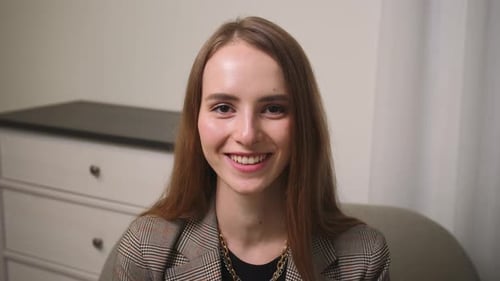 Confident Smiling Young Woman Looking at Camera Standing at Home Office