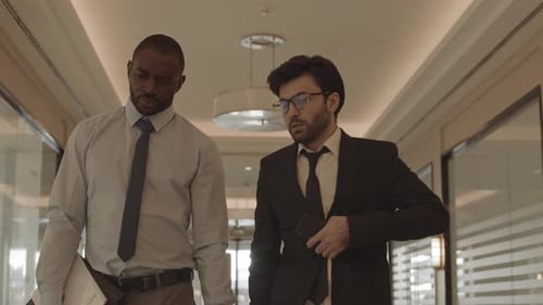Businessmen Confidently Walk in Office Corridor