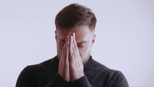 Man Praying Indoors, Close Up