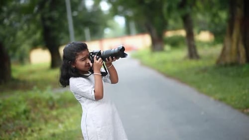Girl Takes Photos with Camera on Rural Path