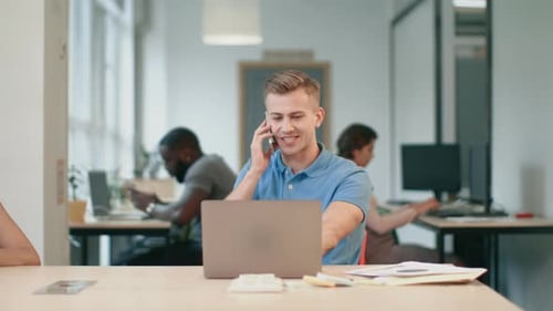 Young Man Talking Mobile Phone at Office