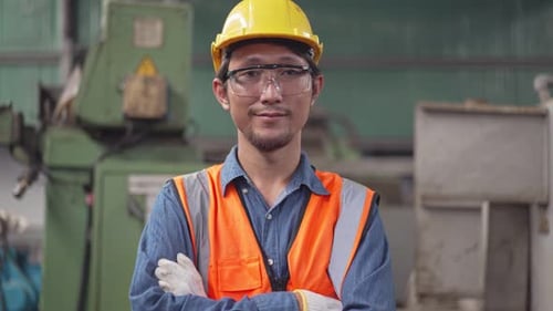 Smiling Construction Worker with Safety Gear in Factory