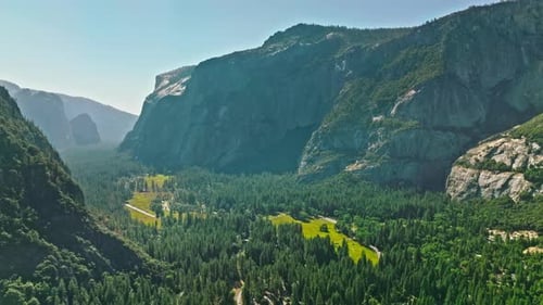 View of Yosemite Valley with evergreen forests visible in the background