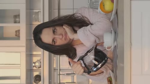 Woman Enjoying Morning Coffee in Cozy Kitchen
