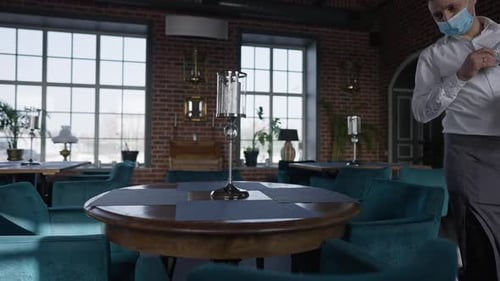 Masked Server Reserving Table in Restaurant