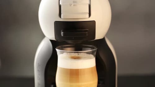 Coffee Machine Making Latte into a Glass