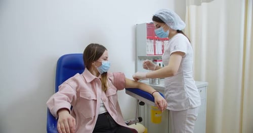 Patient receiving blood draw at medical clinic
