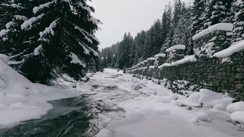 Aerial View Drone Moving Above the Frozen River in Mountains