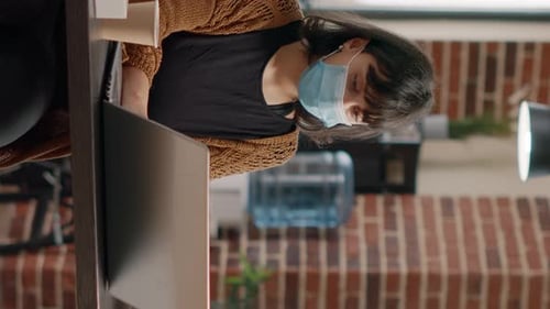 Woman Working at Computer Wearing Face Mask
