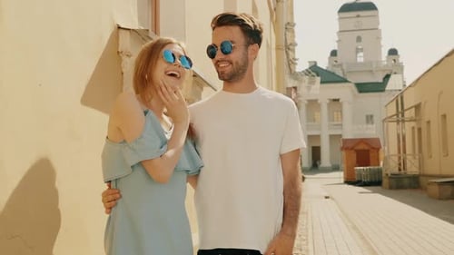 Laughing Couple in City Street With Tower View