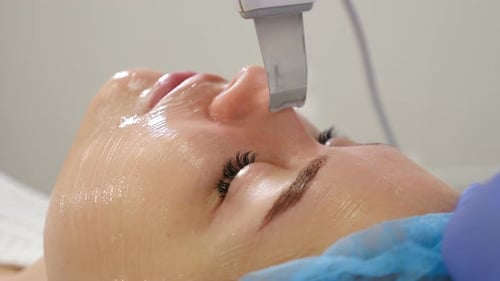 Beauty Clinic and Machine Cosmetology. Professional Cosmetologist Working with Ultrasonic Facial