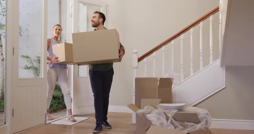 Caucasian attractive couple moving into new house