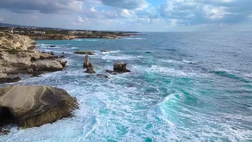 Aerial View of Crashing Waves on Rocks