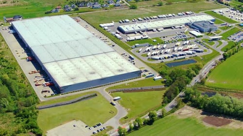 Aerial view of goods warehouse. Logistics center in industrial city zone from above. Aerial view of