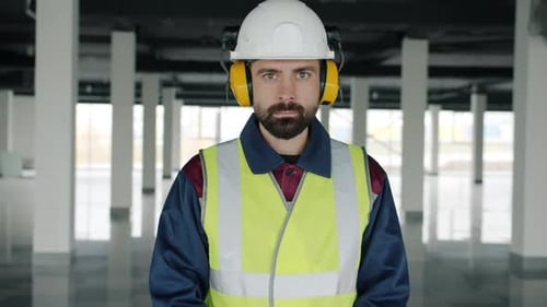 Man Wearing Safety Gear Standing in Modern Office