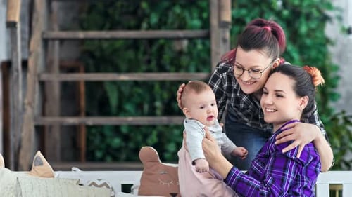 Two Women Loving Baby in a Cozy Home