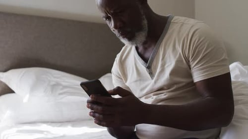 Mature Adult Using Smartphone in Bed