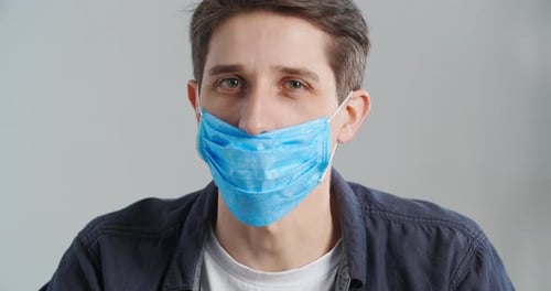 Man Wearing Surgical Mask Gives Thumbs Up