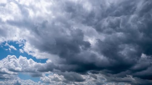 Rolling Gray Clouds Across Bright Blue Sky