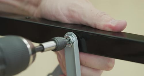 Tightening Bolt with Screwdriver and Wrench Close-up