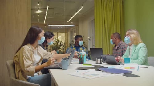 Business Team in Face Masks Meeting at Office