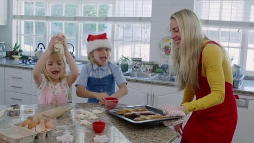 Family Baking Christmas Cookies in Kitchen