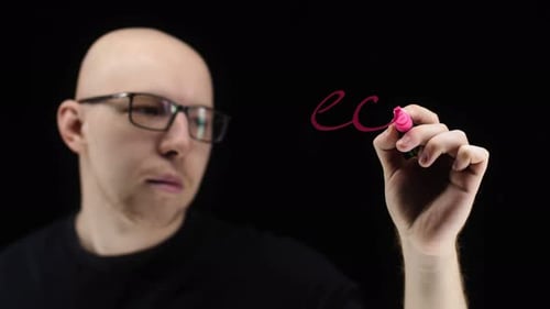 Man Writes "Economy" with Marker on Transparent Surface