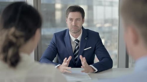 Rear Back View of Workers Having Meeting with Middle Aged Businessman