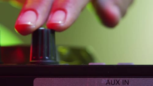 Fingers Adjusting Audio Mixer Knobs