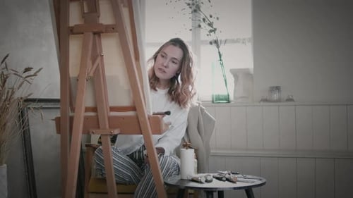 Young Woman Painting at Home in Art Studio