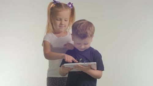 Girl and Boy Interact with Tablet Device