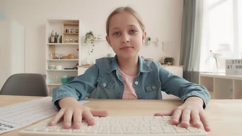 Girl Typing on Keyboard at Home Homeschooling