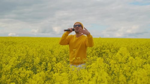 Wearing Sunglasses and a Field of Yellow Flowers, the Male Soloist in Yellow Clothes Dances and