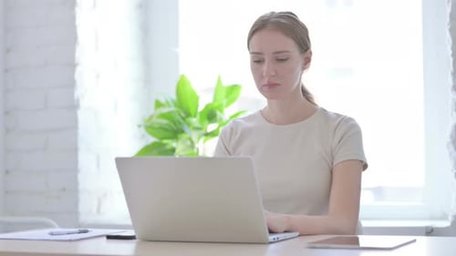 Woman Working on Laptop with Neck Pain