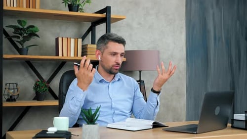 Man On Video Conference Call In Modern Office