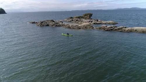 Epic Kayaking Aerial Passing Man Paddling By Islands In Pacific Ocean