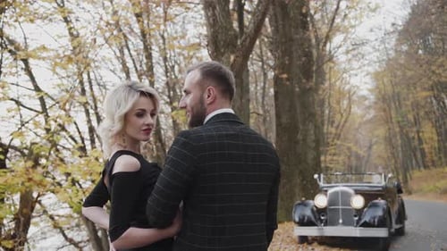 Happy Couple in Love Stands in Pose in Autumn Park in Retro Style