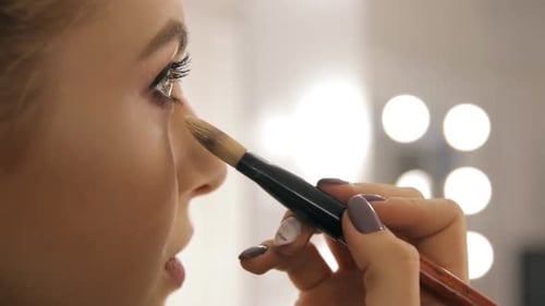 Woman Getting Makeup Applied with Brush Close Up