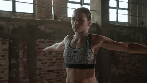 Exercise. Fit woman warming up before fitness workout at gym